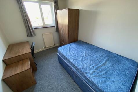 Cozy double bedroom featuring a comfortable bed...