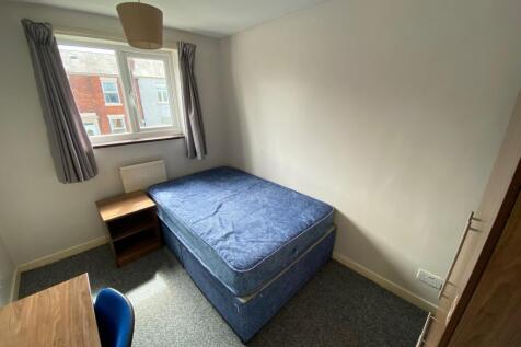 This cozy double bedroom features a comfortable...