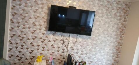 A cozy living room featuring a stylish geometri...