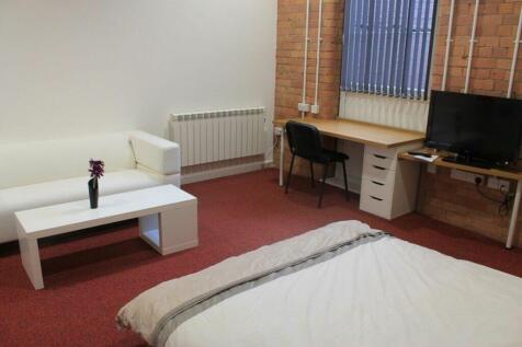 This spacious double bedroom features a cozy at...