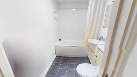A bright and clean bathroom featuring a large b...