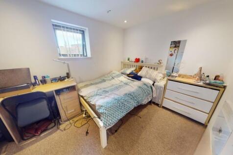 A cozy and neat double bedroom featuring a comf...