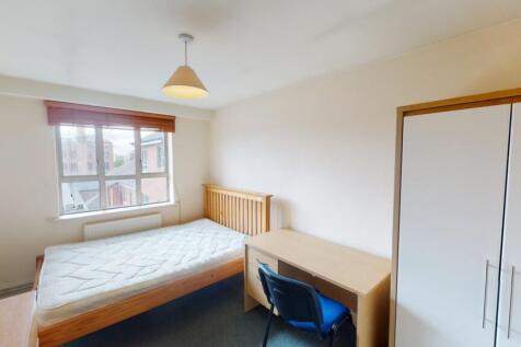 Bright and tidy double bedroom featuring a wood...