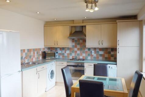 Bright and modern kitchen featuring a tiled bac...