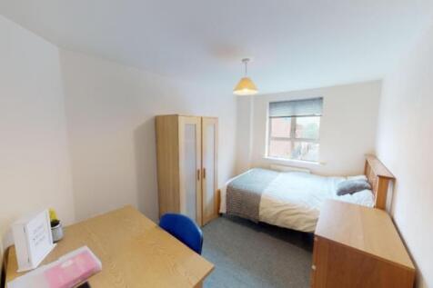 Bright and cozy single bedroom featuring a comf...