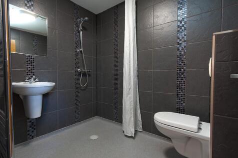 A modern and stylish bathroom featuring elegant...