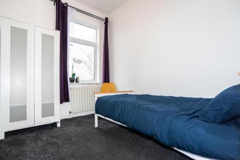 Cozy double bedroom featuring a comfortable bed...