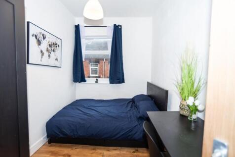 Cozy double bedroom featuring a comfortable bed...