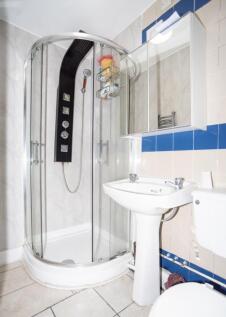 This modern bathroom features a sleek shower en...