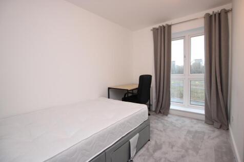 Bright, simply furnished bedroom with a single ...