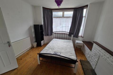 A cozy double bedroom featuring large windows t...