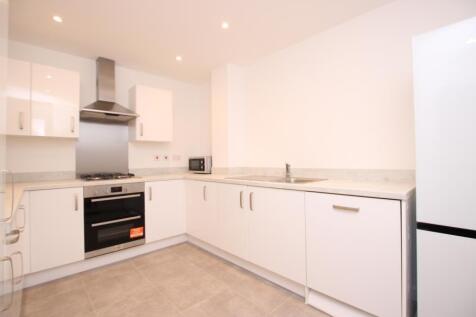 Bright modern kitchen with white gloss cabinets...