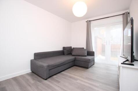 Bright, modern living room with a grey L-shaped...