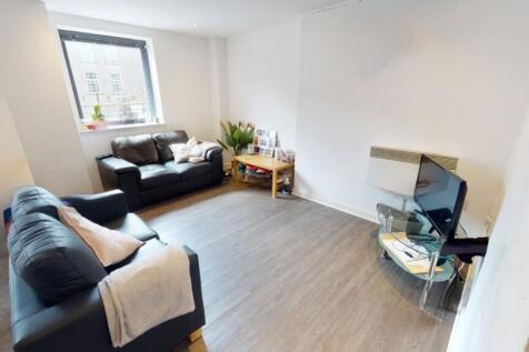 A bright and welcoming living room featuring tw...