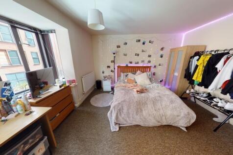 Bright and spacious master bedroom featuring a ...