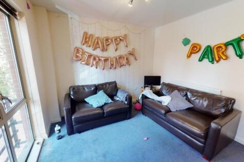 A cheerful living room featuring two dark leath...