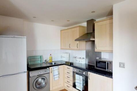 Bright and modern kitchen featuring light wood ...