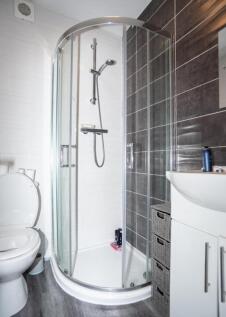 A modern bathroom featuring a stylish shower en...