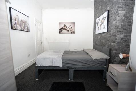 Cozy double bedroom featuring a stylish gray be...