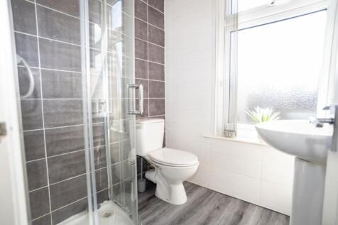 This modern bathroom features a sleek shower en...