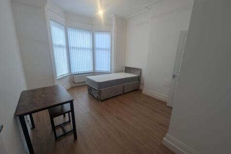Spacious double bedroom featuring ample natural...