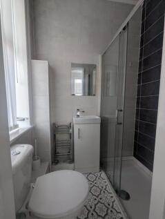 A modern bathroom featuring a sleek shower, sty...