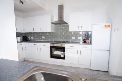 Bright and modern kitchen featuring sleek white...