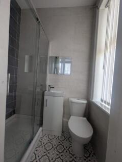 A modern bathroom featuring a sleek shower encl...