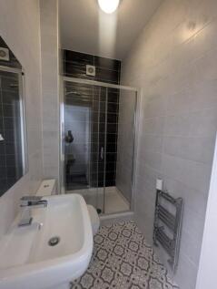 This modern bathroom features sleek tiles and a...