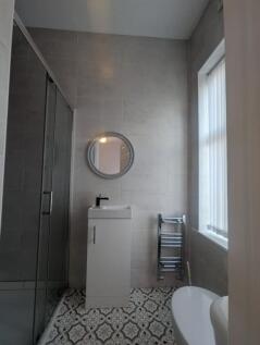 A stylish and modern bathroom featuring a sleek...