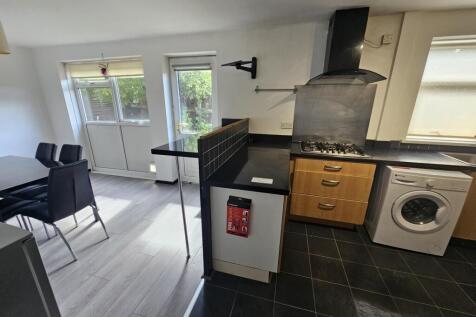 Modern kitchen area with ample natural light, f...