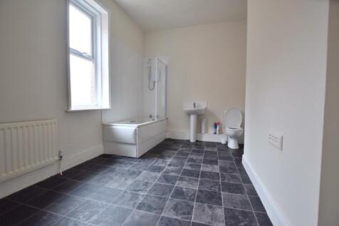 A spacious and bright bathroom featuring both a...