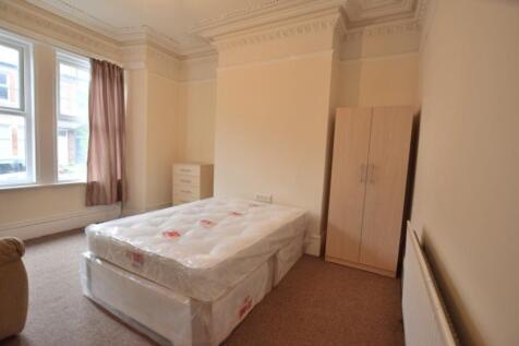 A spacious and well-lit double bedroom featurin...