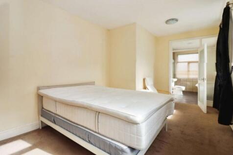Spacious double bedroom featuring ample natural...
