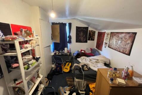A cozy double bedroom with a creative atmospher...