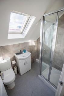 Bright and modern bathroom featuring a spacious...