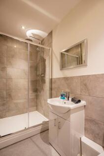 A modern bathroom featuring a walk-in shower wi...
