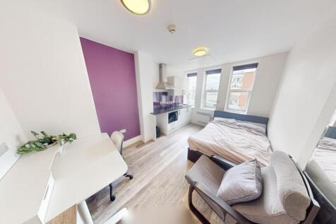 This inviting double bedroom features a cozy la...