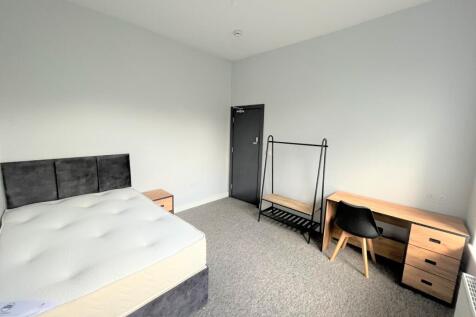 A spacious and bright double bedroom featuring ...