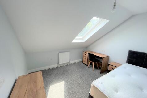 A bright and inviting double bedroom featuring ...