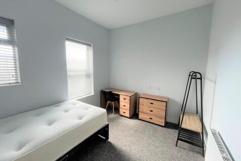 A spacious and bright double bedroom featuring ...