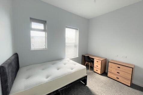 A bright and spacious double bedroom featuring ...