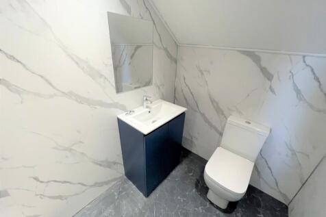A modern and stylish bathroom featuring elegant...
