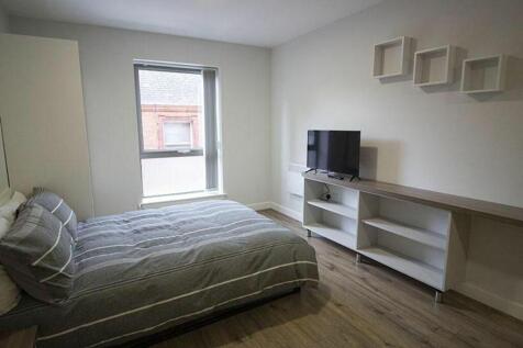 This cozy double bedroom features ample natural...