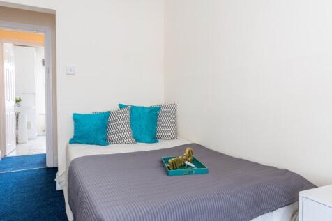 Cozy double bedroom featuring a comfortable bed...