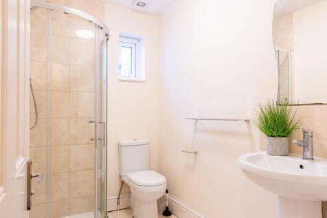 A modern bathroom suite featuring a spacious wa...