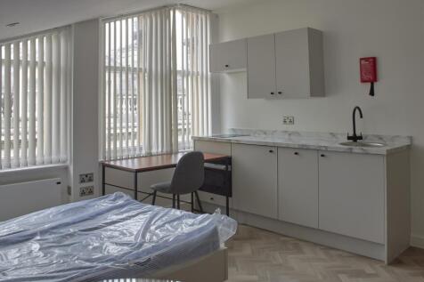 A bright and modern kitchenette with ample spac...