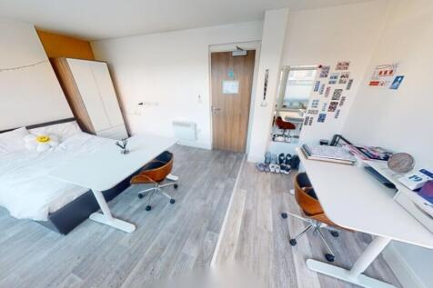 A spacious double bedroom featuring two study a...
