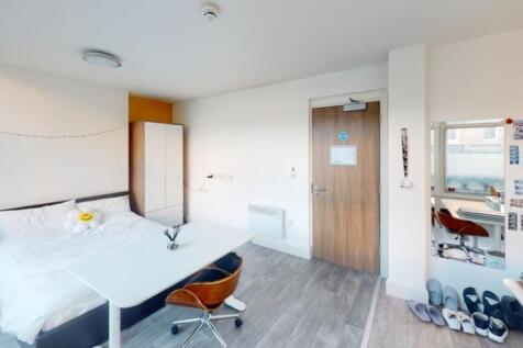 This spacious double bedroom features large win...