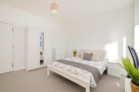 Bright and airy double bedroom featuring a comf...